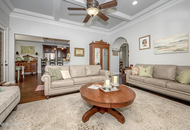 living area featuring wood finished floors, coffered ceiling, arched walkways, crown molding, and beamed ceiling