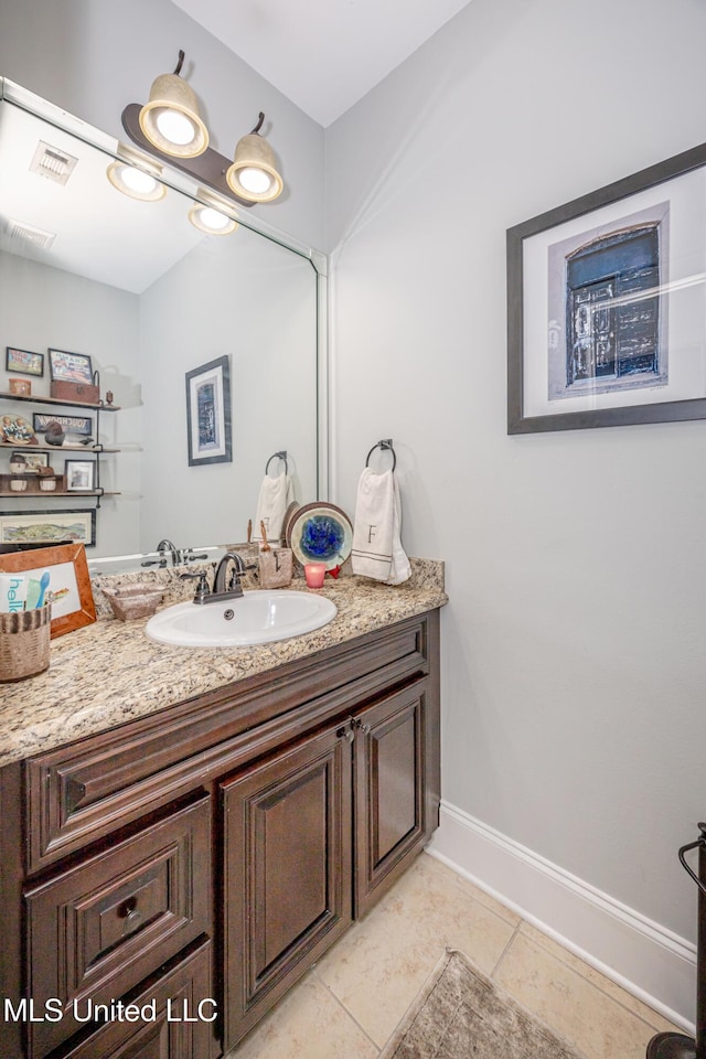 bathroom with tile patterned floors, visible vents, vanity, and baseboards