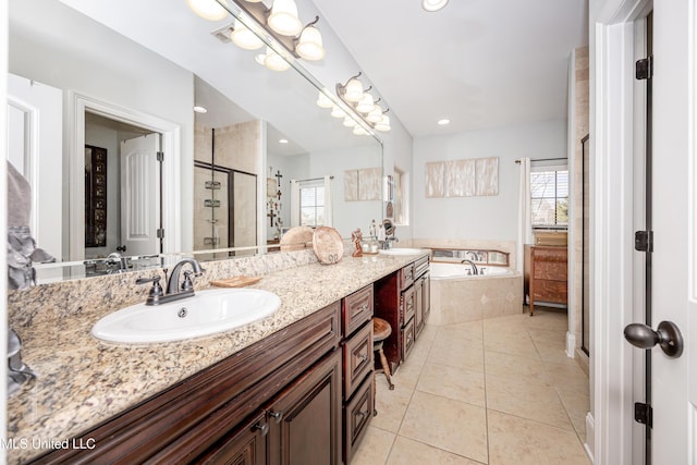 full bath with double vanity, a stall shower, a sink, tile patterned floors, and a bath