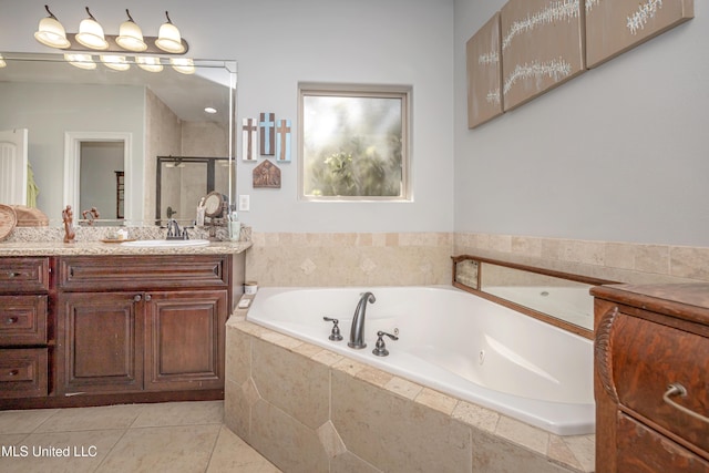 bathroom featuring a tub with jets, a stall shower, vanity, and tile patterned flooring