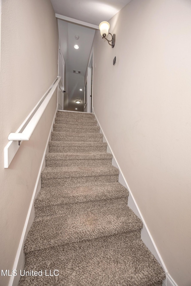 stairway with recessed lighting, baseboards, and carpet floors