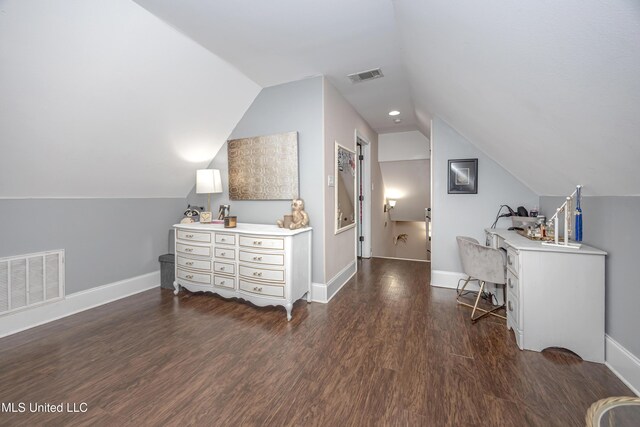 interior space with dark wood finished floors, visible vents, lofted ceiling, and baseboards