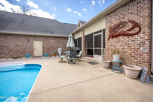 view of swimming pool featuring a fenced in pool, outdoor dining area, and a patio area