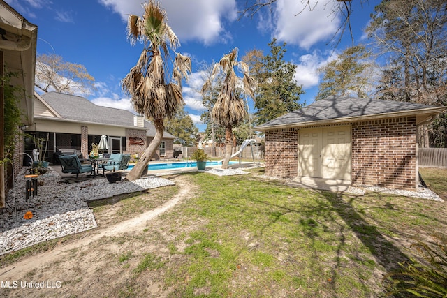 view of yard featuring a fenced in pool, a patio, an outdoor structure, and a fenced backyard