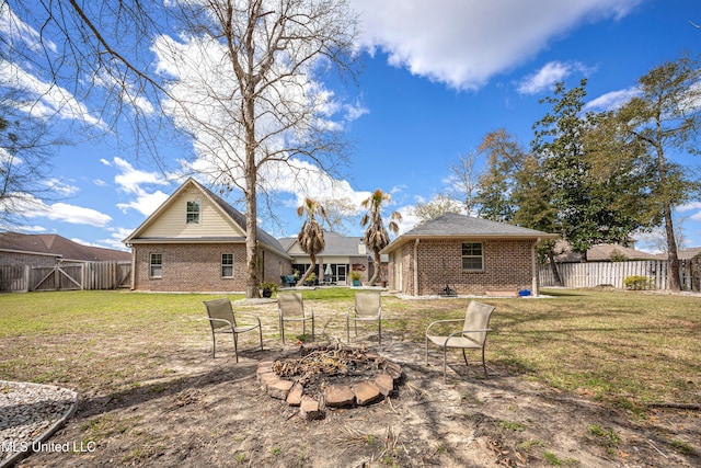 view of yard with a patio area, a fire pit, and fence