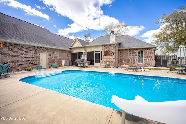 view of pool with a patio area, a fenced in pool, and fence