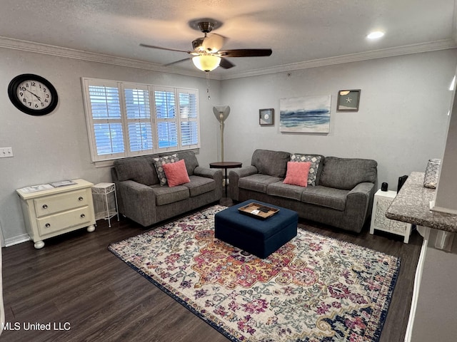 living room with a textured ceiling, crown molding, ceiling fan, and dark wood-type flooring