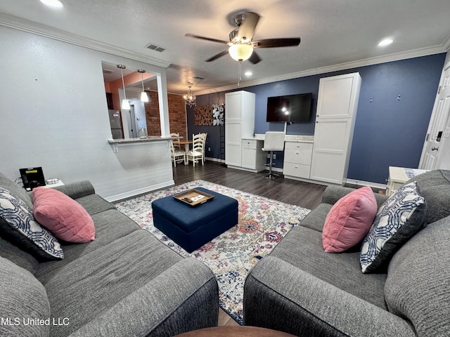 living room featuring ceiling fan with notable chandelier, dark hardwood / wood-style floors, and ornamental molding