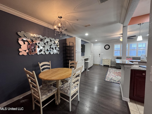 dining area featuring a textured ceiling, ceiling fan with notable chandelier, crown molding, and dark wood-type flooring