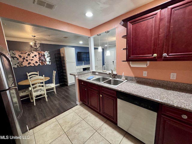 kitchen featuring appliances with stainless steel finishes, light wood-type flooring, ornamental molding, sink, and hanging light fixtures