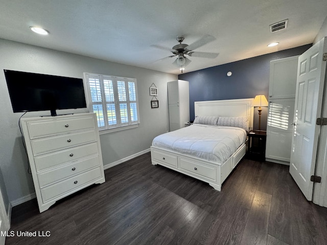 bedroom with ceiling fan and dark wood-type flooring