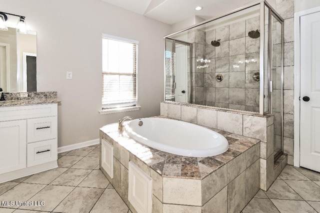 bathroom with tile patterned floors, vanity, and shower with separate bathtub