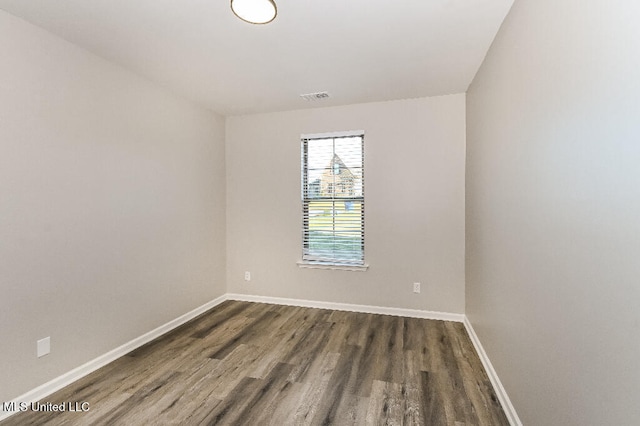 spare room featuring dark wood-type flooring