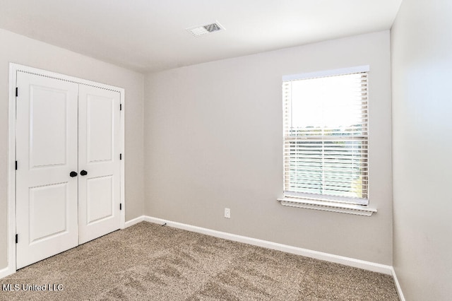 unfurnished bedroom featuring carpet floors and a closet