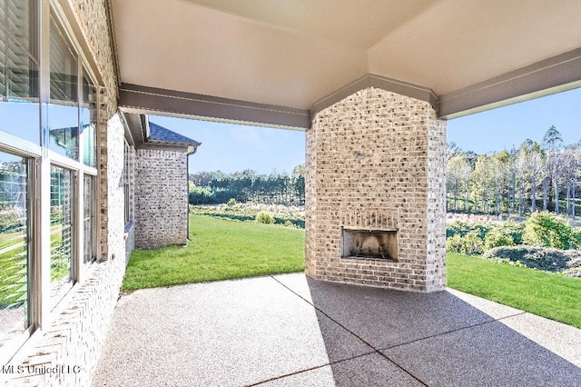 view of patio / terrace featuring an outdoor brick fireplace