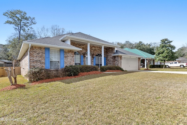 view of front of house with brick siding, a front yard, fence, a garage, and driveway