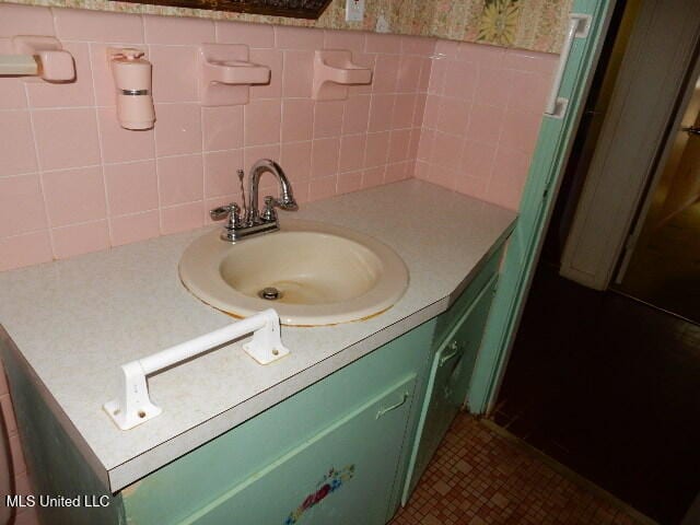 bathroom featuring vanity, tasteful backsplash, tile patterned floors, and tile walls