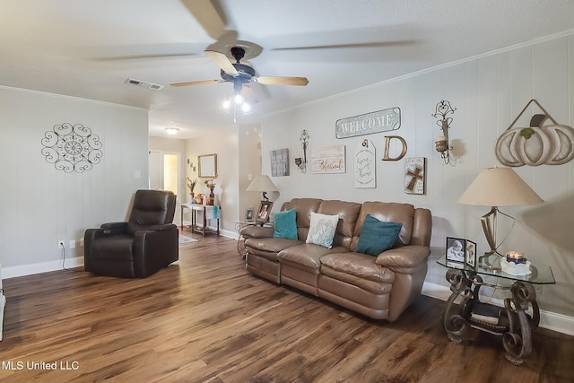 living area featuring visible vents, crown molding, and wood finished floors