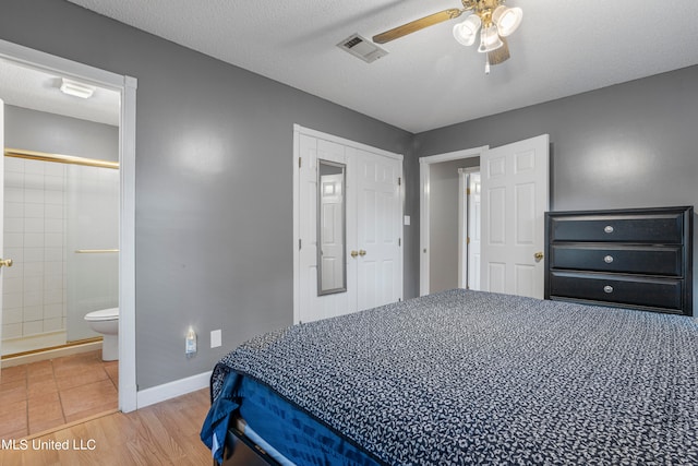 bedroom with hardwood / wood-style floors, ensuite bathroom, a textured ceiling, and ceiling fan