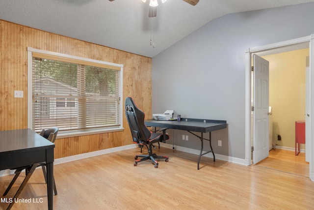 home office featuring wood-type flooring and wood walls