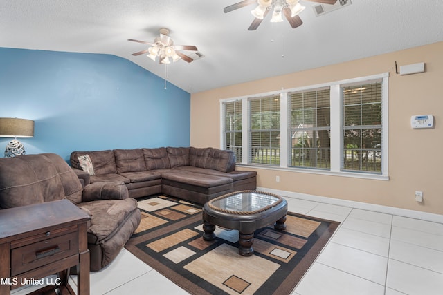 tiled living room with a textured ceiling, ceiling fan, and vaulted ceiling