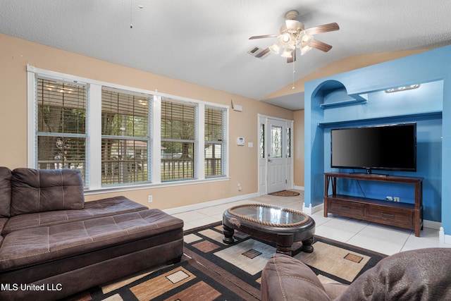 living room featuring lofted ceiling, light tile patterned flooring, a textured ceiling, and ceiling fan