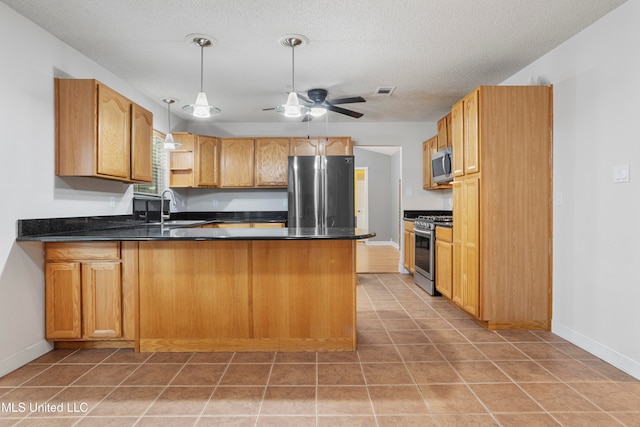 kitchen with kitchen peninsula, decorative light fixtures, stainless steel appliances, and sink