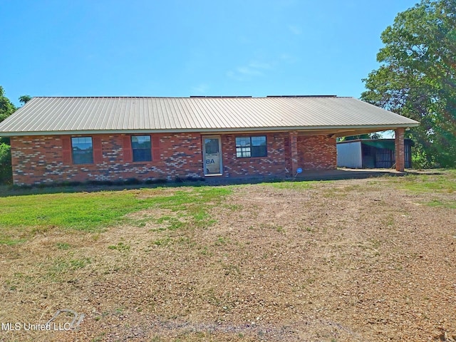 120 Harrison Ln, Yazoo City, MS 39194 - view of home's exterior with brick siding, an attached carport, and metal roof