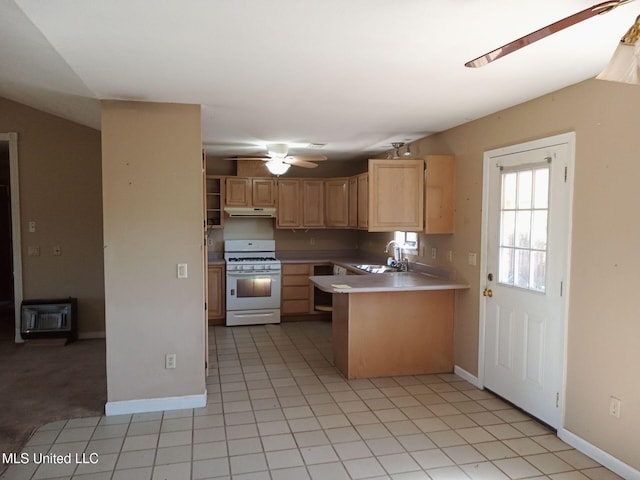 120 Harrison Ln, Yazoo City, MS 39194 - kitchen with white gas range, light brown cabinets, a sink, under cabinet range hood, and light countertops