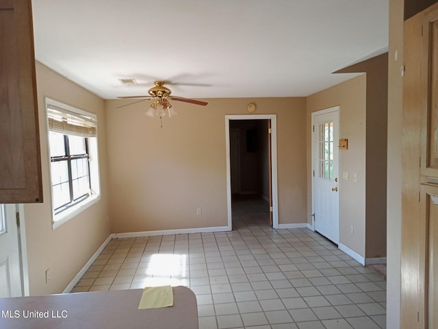 120 Harrison Ln, Yazoo City, MS 39194 - unfurnished room with healthy amount of natural light, a ceiling fan, light tile patterned flooring, and baseboards