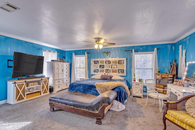 bedroom with ceiling fan, crown molding, and carpet flooring