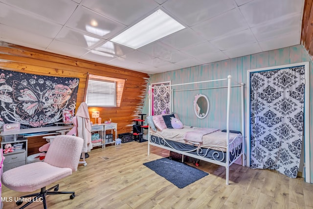 bedroom with hardwood / wood-style flooring and a drop ceiling