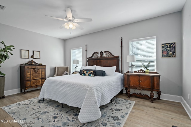 bedroom with light hardwood / wood-style floors, multiple windows, and ceiling fan