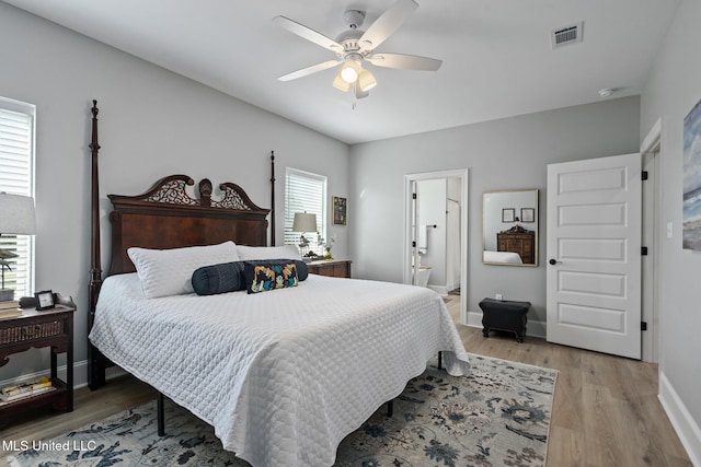 bedroom featuring ceiling fan, hardwood / wood-style flooring, and multiple windows