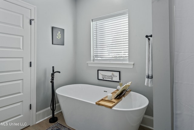 bathroom featuring a bathtub and hardwood / wood-style flooring