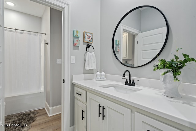 bathroom featuring vanity, curtained shower, and wood-type flooring