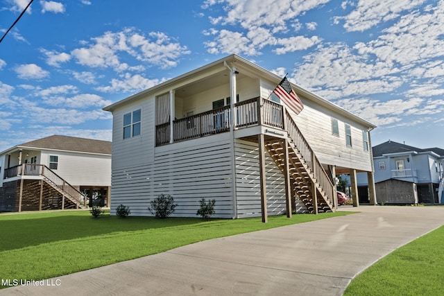 back of house with a lawn