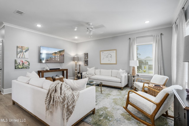 living room featuring crown molding, hardwood / wood-style flooring, and ceiling fan