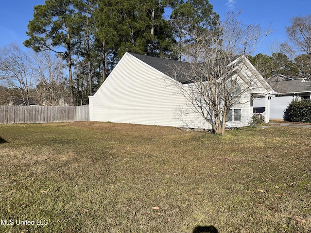 view of side of home featuring a yard