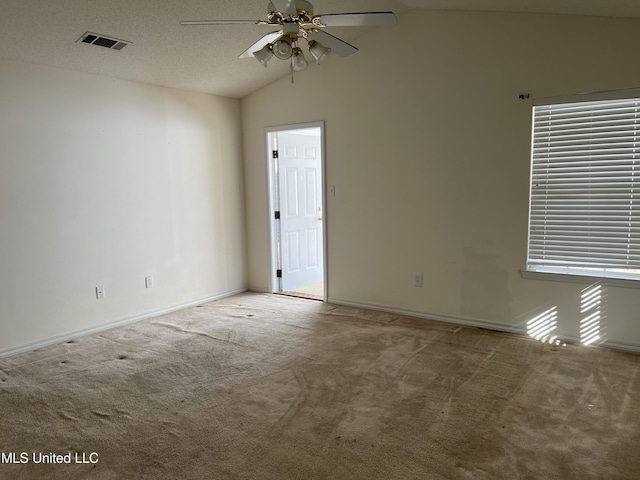 carpeted empty room with ceiling fan and lofted ceiling