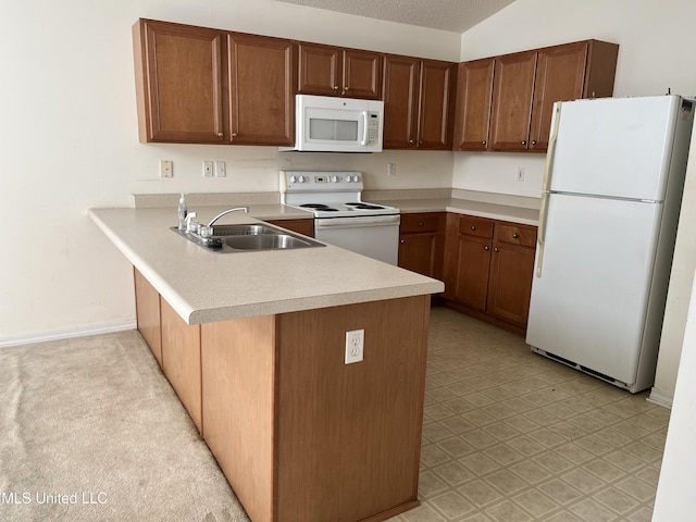 kitchen with a textured ceiling, sink, kitchen peninsula, and white appliances