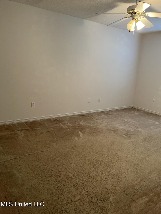 spare room with a textured ceiling, ceiling fan, and carpet flooring