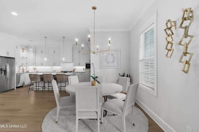 118 Seymour Dr, Madison, MS 39110 - dining room with wood finished floors, a chandelier, baseboards, and recessed lighting