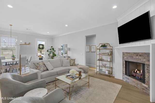 118 Seymour Dr, Madison, MS 39110 - living area with a brick fireplace, light wood-style floors, recessed lighting, crown molding, and a chandelier