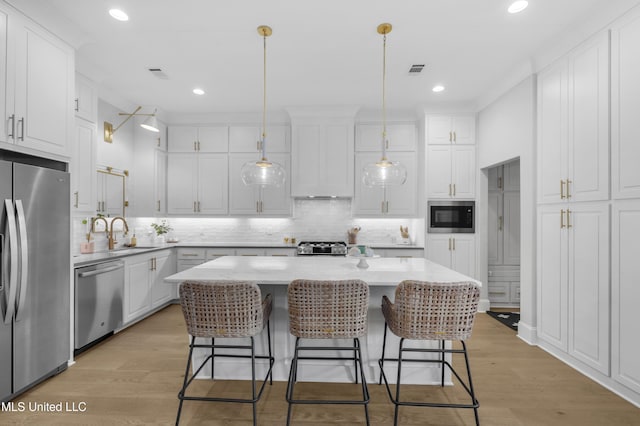 118 Seymour Dr, Madison, MS 39110 - kitchen featuring stainless steel appliances, backsplash, light countertops, white cabinetry, and recessed lighting