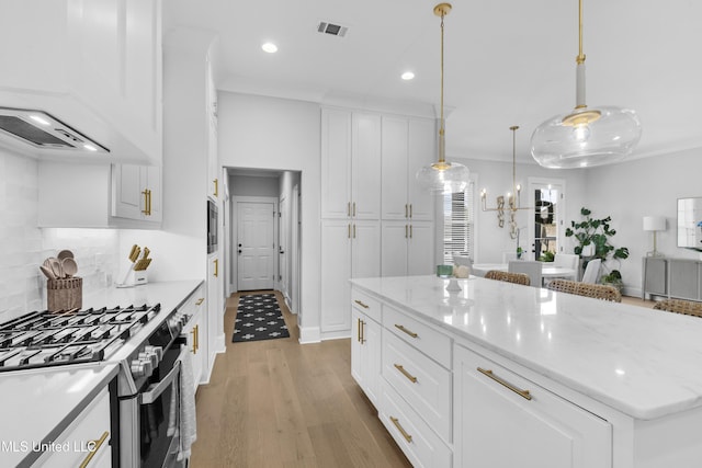 118 Seymour Dr, Madison, MS 39110 - kitchen with gas range, recessed lighting, light wood-style flooring, white cabinets, and hanging light fixtures