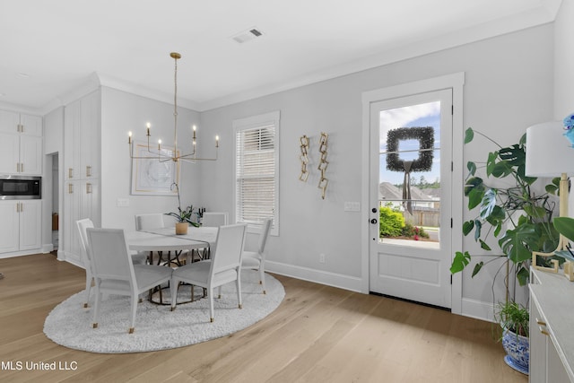 118 Seymour Dr, Madison, MS 39110 - dining area featuring a chandelier, light wood finished floors, and baseboards