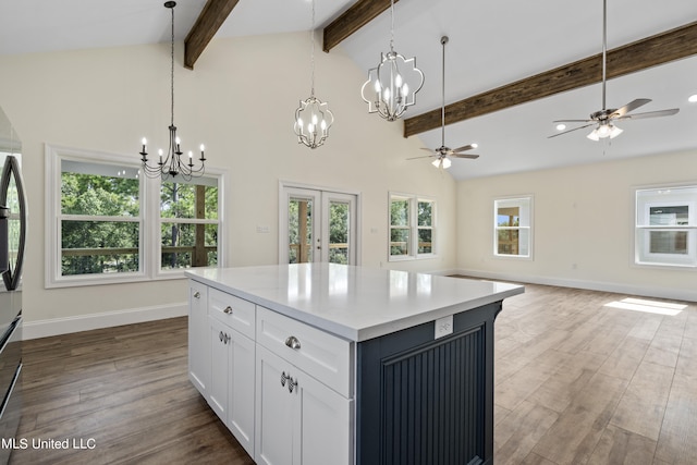 kitchen featuring white cabinetry, beamed ceiling, a kitchen island, and dark hardwood / wood-style floors