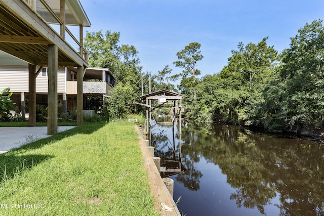 view of dock featuring a yard and a water view