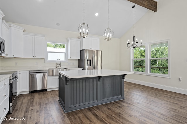 kitchen featuring appliances with stainless steel finishes, a center island, white cabinetry, beamed ceiling, and dark hardwood / wood-style floors